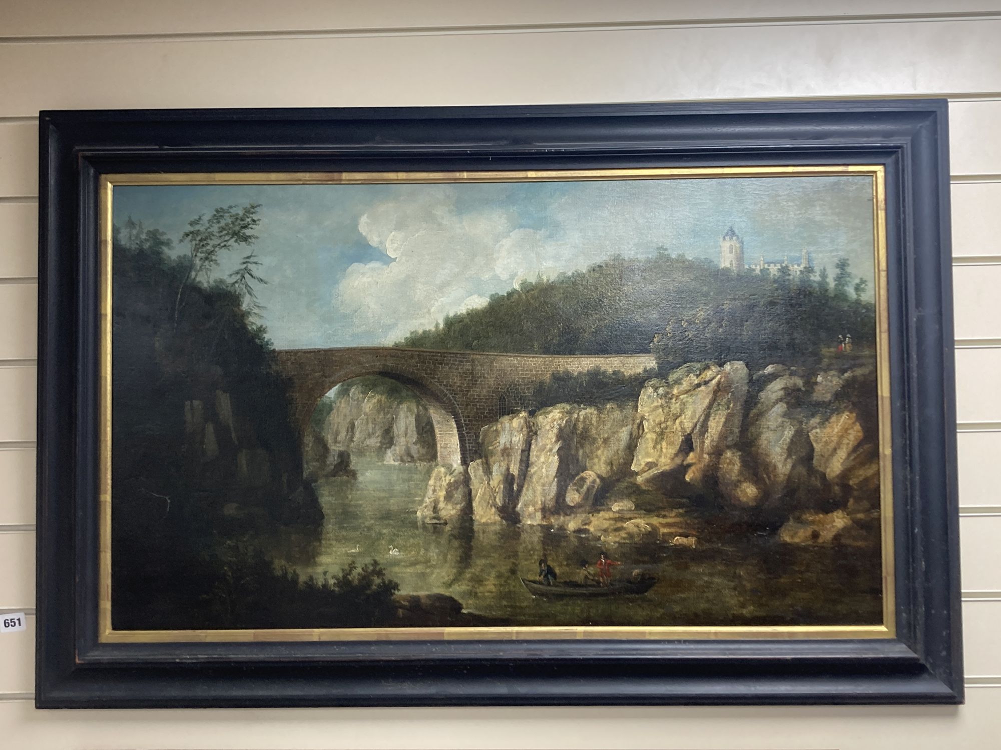 19th century English School, oil on canvas, Stone bridge across a gorge, a castellated county house in the distance, 53 x 90cm